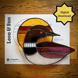 May include: A stained glass loon design with a sunset background. The bird features brown, white, and burgundy glass, with a red eye. The design includes the text "Loon & Sun" and "Digital Download".