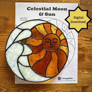 May include: A stained glass sun and moon design with the text "Celestial Moon & Sun" and "Digital Download". The sun is orange and yellow with a smiling face. The moon is white. A paper with numbered sections is behind the glass.