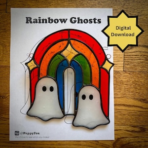 May include: A stained glass suncatcher featuring two white ghosts positioned in front of a rainbow arch. The piece is displayed on a printed pattern sheet titled Rainbow Ghosts with a yellow starburst graphic labelled Digital Download.