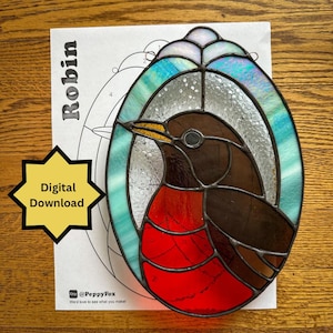 May include: Stained glass robin with a red breast, brown body, and yellow beak, set against a background of blue and clear glass. The design is oval-shaped. A paper with the word "Robin" and a "Digital Download" starburst are also visible.