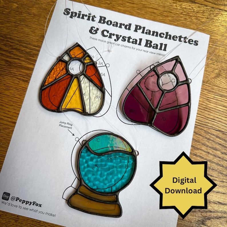 May include: Stained glass spirit board planchette and crystal ball charms in orange, yellow, pink, and teal. The charms are on a white paper with the text "Spirit Board Planchettes & Crystal Ball" and "Digital Download".