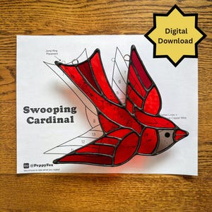 May include: A stained glass cardinal bird in flight, predominantly red with darker red and gray accents. The design is on a white paper with the text "Swooping Cardinal" and "Digital Download".