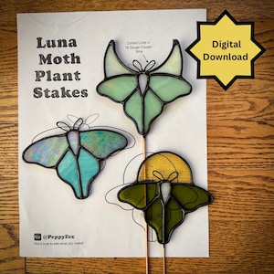 May include: Three stained glass luna moth plant stakes in shades of green, blue, and yellow. The stakes are on copper rods. The image includes the text "Luna Moth Plant Stakes" and "Digital Download".