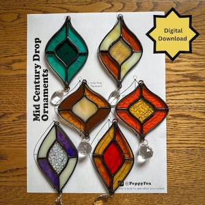 May include: Six stained glass ornaments in a diamond shape with various coloured glass panels and clear crystal drops. The paper background features the text Mid Century Drop Ornaments, Jump Ring Placement, Digital Download, and @PeppyFox.