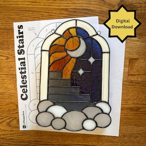 Könnte beinhalten: Ein Buntglasfenster mit einer himmlischen Szene aus Mondsichel, Sonnenstrahlen und Sternen über einer Treppe, das auf einer Papiervorlage mit der Aufschrift Celestial Stairs und einem Digital Download-Sternsymbol liegt.