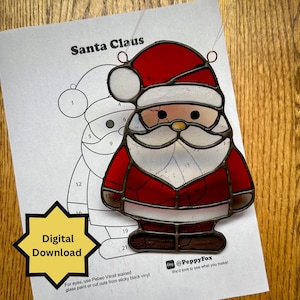May include: A stained glass Santa Claus ornament with a red hat and suit, white beard, and clear face. The ornament is on a paper with a Santa Claus outline and the words "Santa Claus" and "Digital Download".