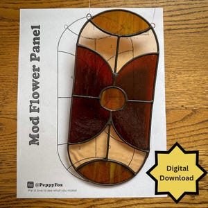 May include: A stained glass panel with a floral design, featuring shades of amber, brown, and cream. The panel is set against a printed template with the text "Mod Flower Panel" and a "Digital Download" graphic.