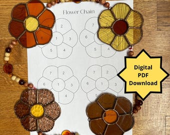 May include: A digital download pattern for a stained glass flower chain. The pattern includes four flower designs with numbered sections for assembly. The image shows three completed stained glass flowers in brown, orange, and yellow.