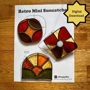 May include: Three colorful stained glass suncatchers in red, orange, yellow, and brown hues. The suncatchers are in various geometric shapes, including a circle, square, and half-circle. The text "Retro Mini Suncatcher" and "Digital Download" are visible.