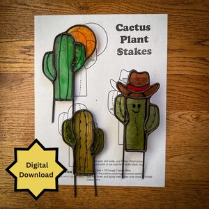 May include: Cactus plant stakes in green, yellow, and orange stained glass. The image includes three cactus designs, one with a cowboy hat. The text "Cactus Plant Stakes" is visible. A yellow star-shaped graphic reads "Digital Download".