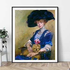 May include: A painting of a woman wearing a blue dress and a large black feathered hat. She is sitting in a chair and holding a small dog. The painting is signed "Louis Corinth 1911".