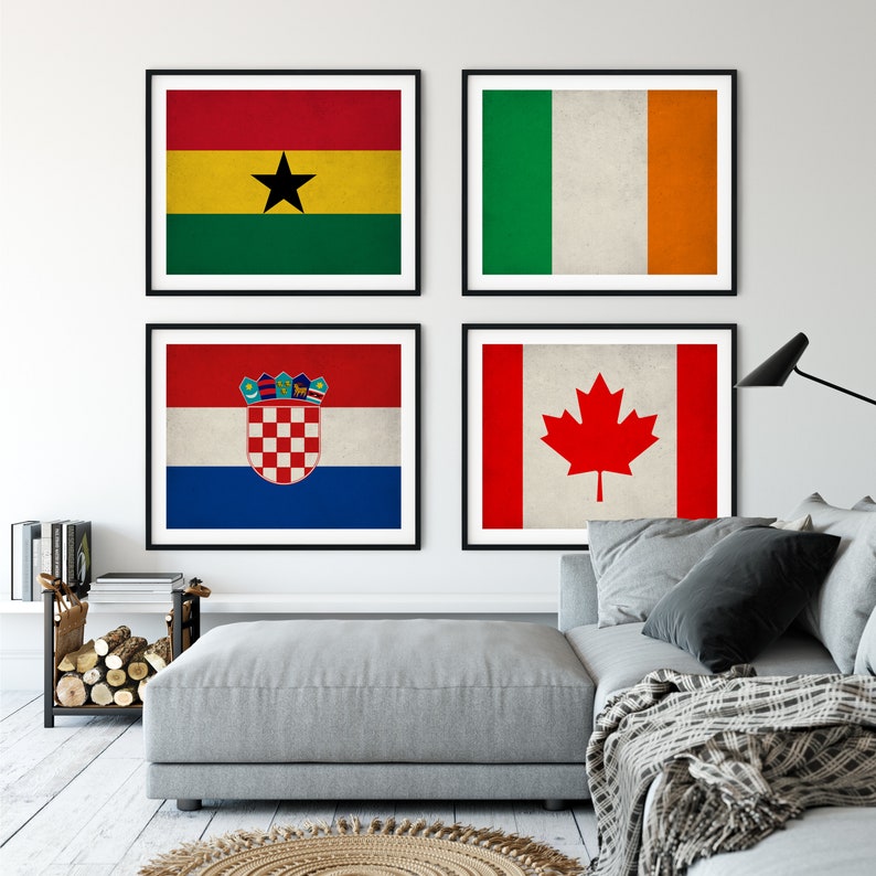 May include: Four framed prints of national flags. The flags are of Ghana, Ireland, Croatia, and Canada. The flags are displayed on a white wall in a living room setting.