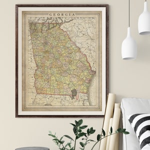 May include: Vintage map of Georgia with county borders and railroads. The map is printed on aged paper with a brown border and the word "GEORGIA" printed at the top.