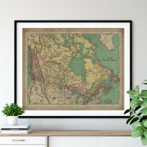 May include: An antique map of British America, printed on aged paper with a cream background. The map shows the provinces of Canada, the United States, and the territories of the Northwest. The map is framed in a black frame.