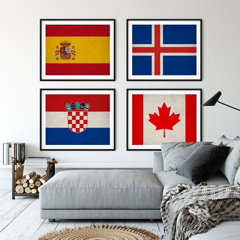 May include: Four framed prints of national flags: Spain, Iceland, Croatia, and Canada. The Spanish flag features red and yellow stripes with a coat of arms. The Icelandic flag has a blue background with a white and red cross. The Croatian flag has red, white, and blue stripes with a coat of arms. The Canadian flag has a red maple leaf.