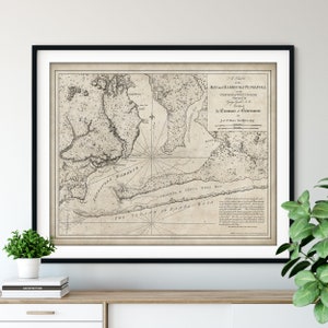 May include: A vintage map of Pensacola Bay and Harbour in the Province of West Florida, surveyed by George Gauld in 1764 and published by Command of Government. The map is printed in black and white on a beige background and features detailed geographic features.