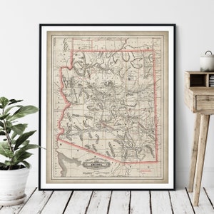 May include: An antique map of Arizona, printed in black and white with red accents. The map shows the state's counties and major cities. The title "Arizona" is printed in a decorative font at the bottom of the map.