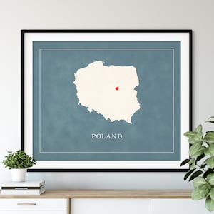 May include: A blue and white print of a map of Poland with a red heart in the center. The text "POLAND" is printed below the map.