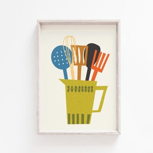 May include: A framed print of a yellow pitcher with a green and white geometric pattern filled with kitchen utensils, including a blue whisk, a wooden spoon, a red spatula, and a wooden whisk.