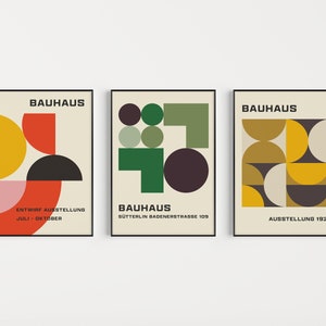 May include: Three Bauhaus art prints with geometric shapes in red, yellow, green, black, and white. The prints have the text "Bauhaus" and the dates "July - October", "Sutterlin Badenerstrasse 109", and "Ausstellung 1923".