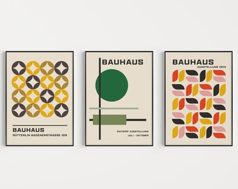 May include: Three Bauhaus style posters with geometric designs in black, white, yellow, red, green, and pink. The posters have the text "Bauhaus" and additional text in German.