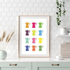May include: A white framed print with a colorful design of 12 Italian coffee pots. The coffee pots are arranged in four rows of three, with each row featuring a different color. The colors are red, orange, yellow, green, blue, purple, pink, teal, light blue, dark blue, and brown.