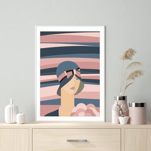 May include: An Art Deco style print depicting a woman in a blue cloche hat with a black and pink bow. The background features horizontal stripes in blue, pink, and beige. The woman wears a pearl necklace and holds a bouquet of flowers.