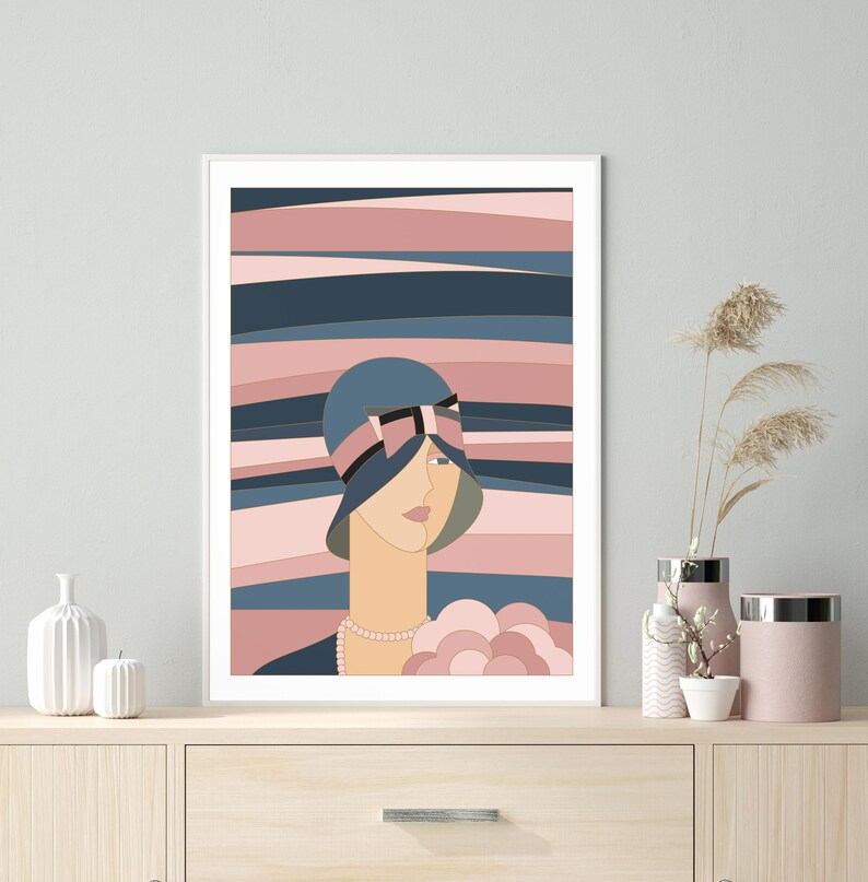 May include: An Art Deco style print depicting a woman in a blue cloche hat with a black and pink bow. The background features horizontal stripes in blue, pink, and beige. The woman wears a pearl necklace and holds a bouquet of flowers.