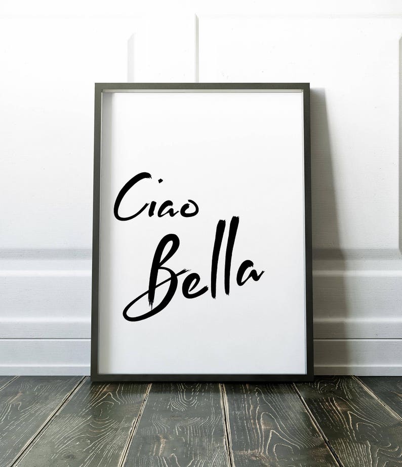 May include: A black framed print with the text "Ciao Bella" in a white background.