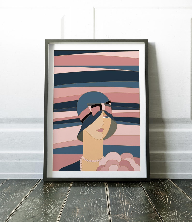 May include: Art print in a black frame, depicting a woman in a blue hat with a black bow and a pearl necklace. The background features horizontal stripes in blue and pink. The artwork is a stylish illustration.