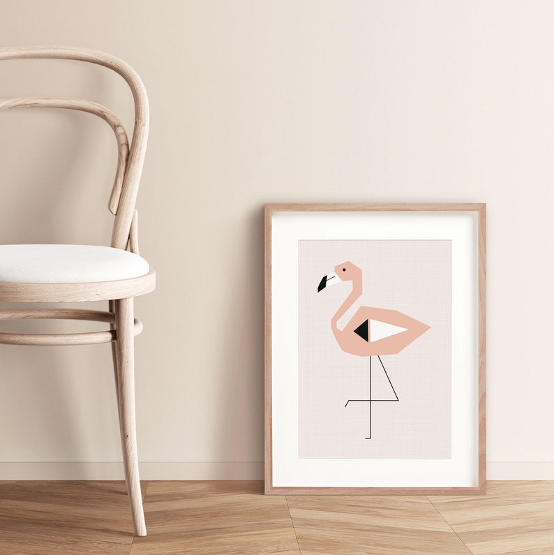 May include: A framed print of a pink flamingo with black and white geometric shapes. The flamingo is standing on one leg with its head tilted to the side. The print is on a light pink background and is framed in a natural wood frame.