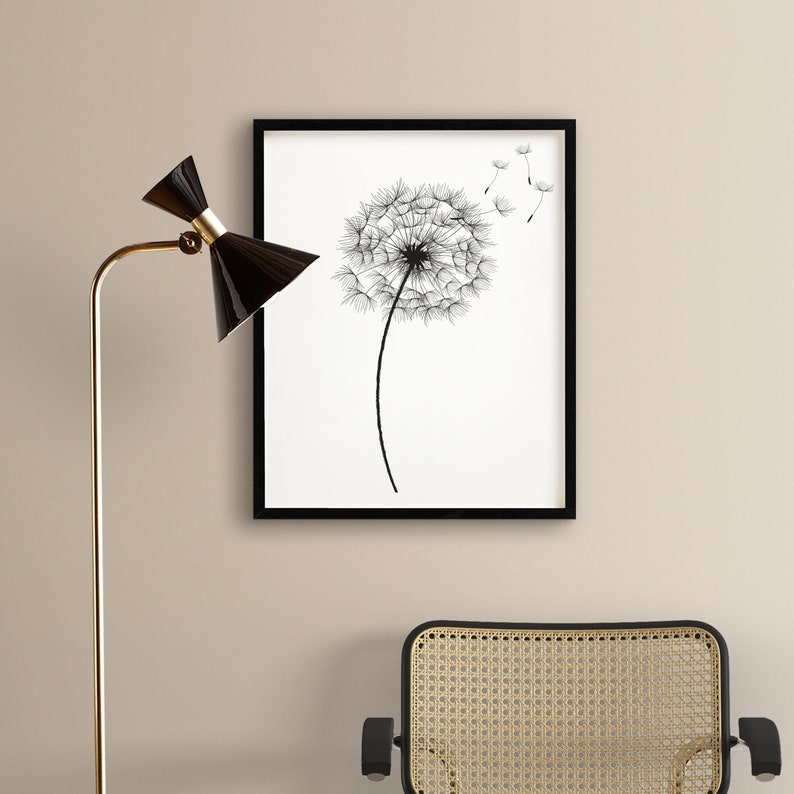 May include: Black and white line art print of a dandelion with seeds blowing in the wind, framed in a black frame.