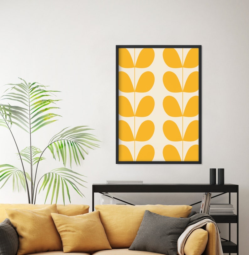 May include: A framed print with a geometric pattern of yellow leaf shapes on a cream background.