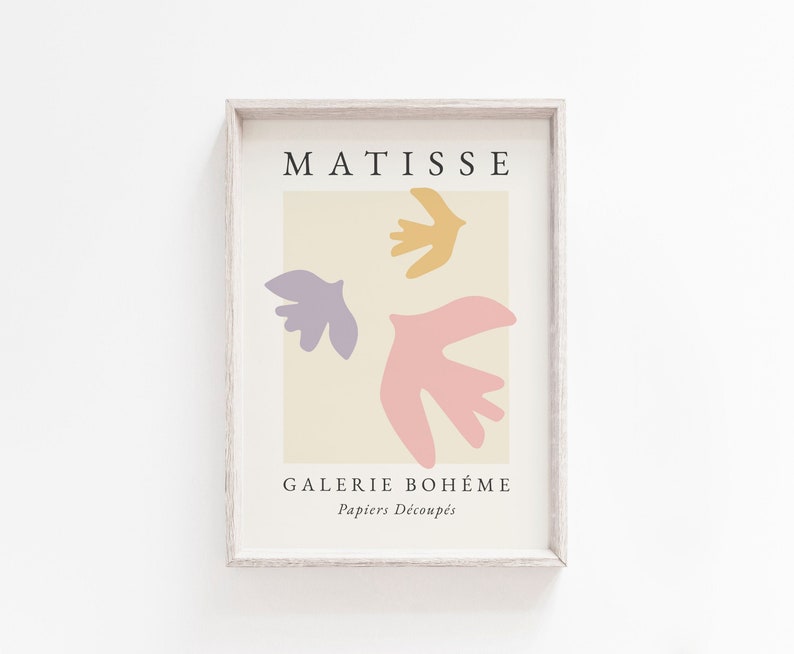May include: A framed print with a beige background featuring three abstract shapes in pink, purple, and yellow. The print has the text "MATISSE" at the top and "GALERIE BOHEME Papiers Decoupes" at the bottom.