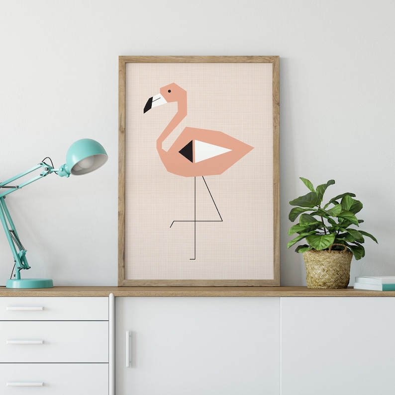 May include: A framed print of a pink flamingo with black and white geometric shapes. The flamingo is standing on one leg with its other leg bent. The background is a light pink with a subtle texture.