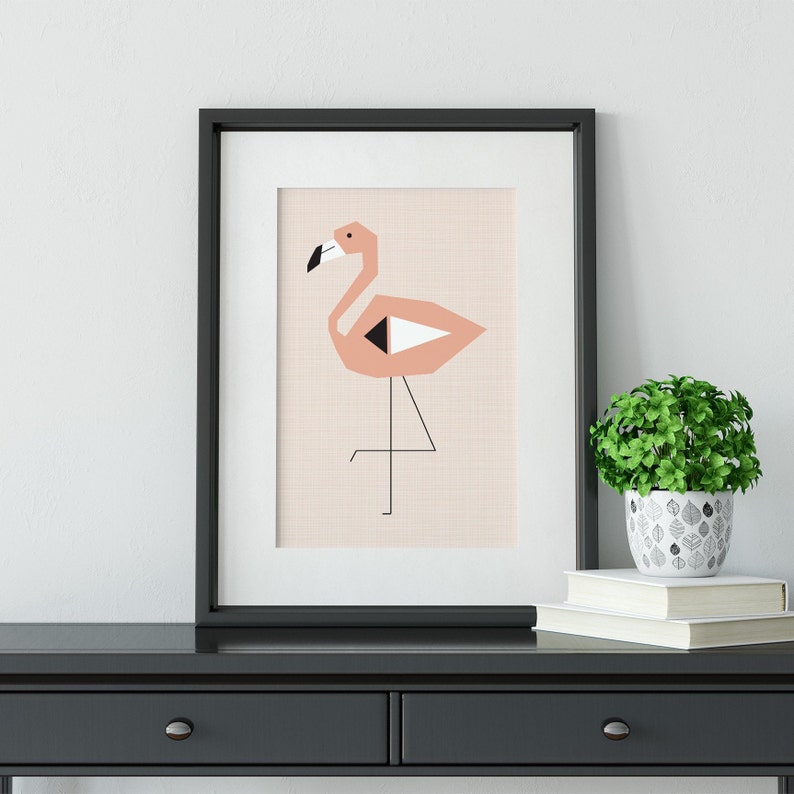 May include: A framed print of a pink flamingo with black and white geometric details on a light pink background.