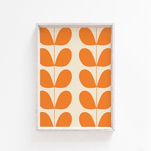 May include: A framed print with a repeating pattern of orange leaf shapes on a cream background.