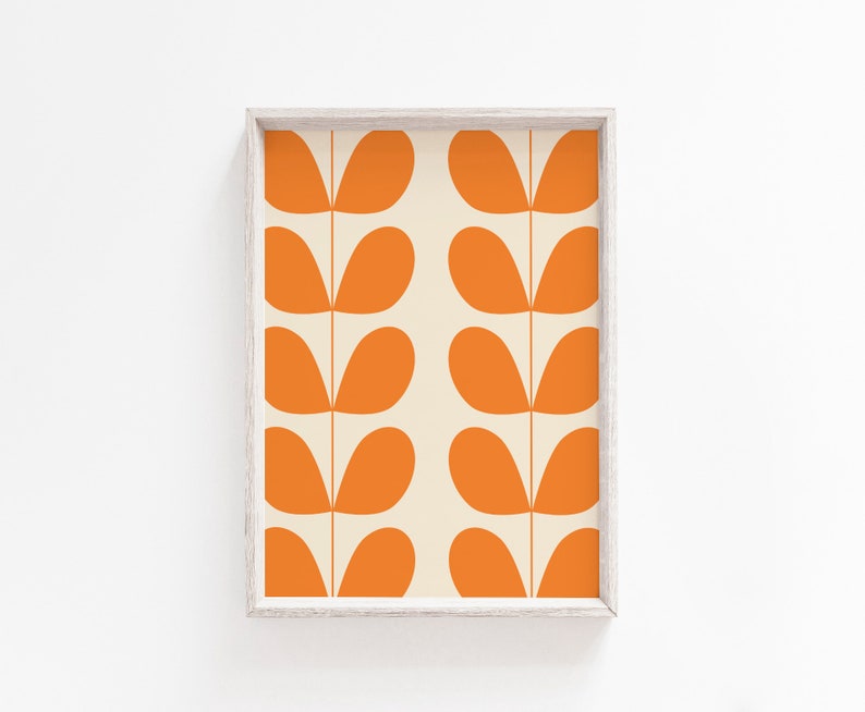 May include: A framed print with a repeating pattern of orange leaf shapes on a cream background.