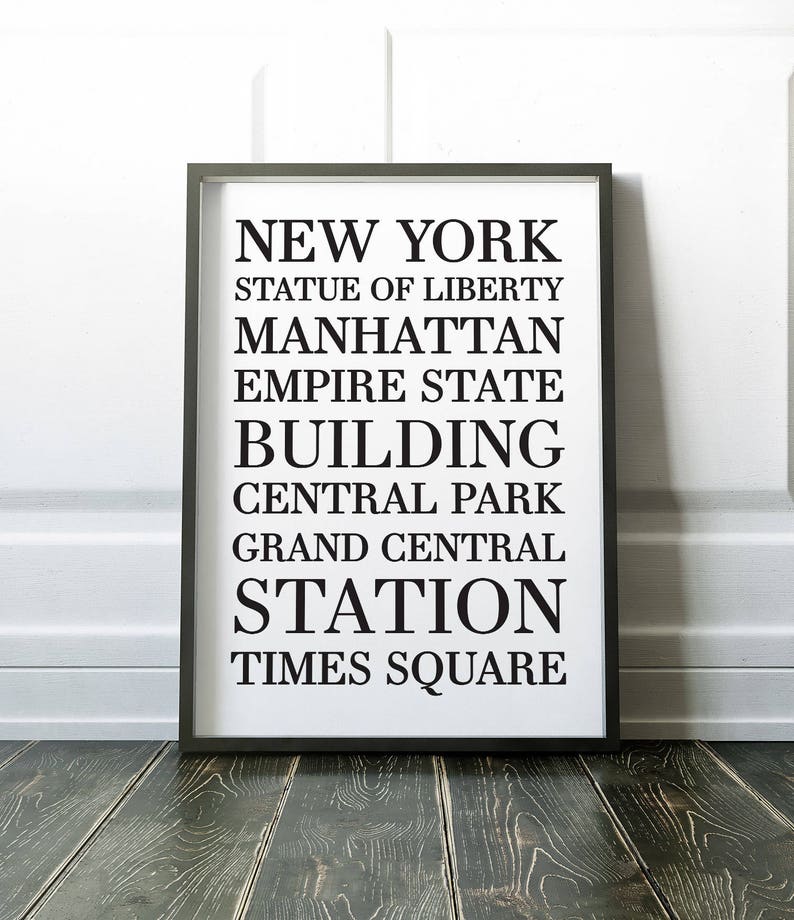 May include: Black and white typography print with the text "NEW YORK" and a list of iconic New York City landmarks, including the Statue of Liberty, Manhattan, Empire State Building, Central Park, Grand Central Station, and Times Square.