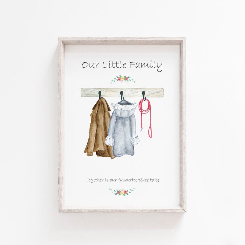 May include: A watercolor illustration of a wooden coat rack with two coats and a leash hanging on it. The text "Our Little Family" is above the rack and "Together is our favourite place to be" is below the rack.