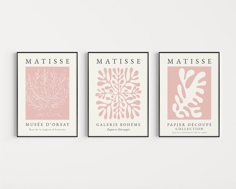May include: Three pink and white art prints with the name "MATISSE" at the top of each print. The prints feature different abstract designs in white on a pink background. The text below each design includes the name of the museum or gallery where the artwork is displayed.
