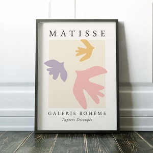 May include: A framed print with a minimalist design featuring three abstract shapes in pink, purple, and yellow. The print is titled "Matisse" and includes the text "Galerie Boh&egrave;me Papiers D&eacute;coup&eacute;s".