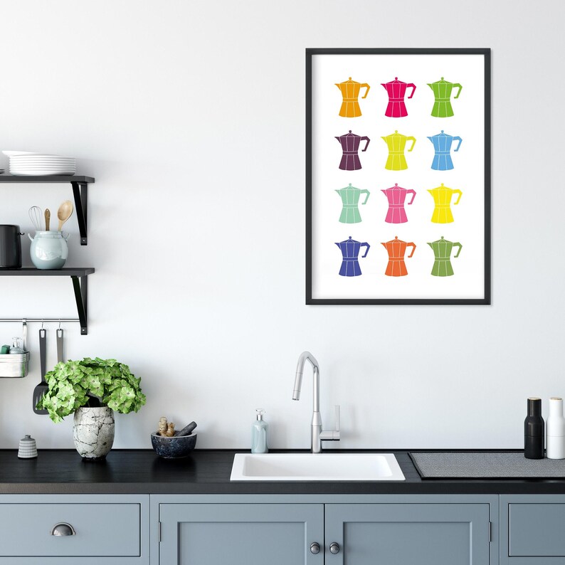 May include: A framed print of a colorful design featuring 12 different colored coffee pots. The coffee pots are all the same shape and size, but each one is a different color, including red, orange, yellow, green, blue, purple, and pink.