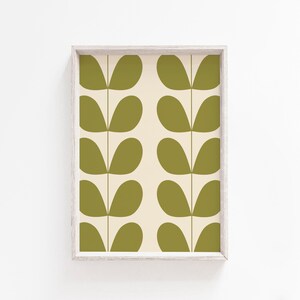 May include: A framed print with a repeating pattern of green leaf shapes on a cream background.