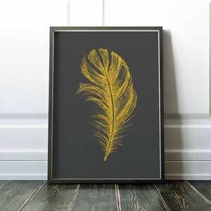 May include: A gold feather illustration on a dark gray background. The feather is detailed and realistic, with a long, thin shaft and a wide, fluffy plume.