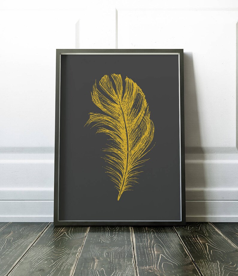 May include: A gold feather illustration on a dark gray background. The feather is detailed and realistic, with a long, thin shaft and a wide, fluffy plume.
