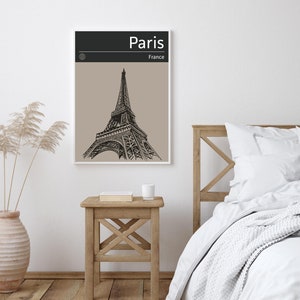 Peut inclure: Une illustration en noir et blanc de la tour Eiffel &agrave; Paris, France. L'illustration est sur un fond beige avec le mot "Paris" en noir en haut et "France" en noir plus petit en dessous.