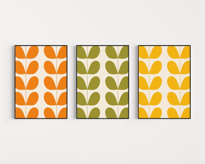 May include: Three framed prints with a retro pattern of stylized leaves in orange, green, and yellow on a white background.