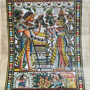 May include: An Egyptian papyrus painting with a detailed border. The artwork depicts figures in traditional attire, holding objects and surrounded by floral elements. The color palette includes gold, blue, red, and green.