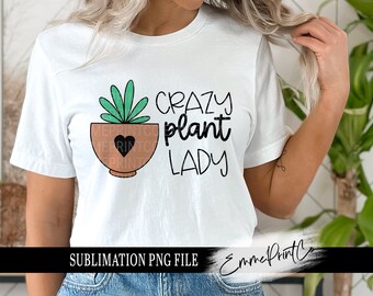 May include: White t-shirt with a black and green plant graphic in a brown pot with a black heart. The text "Crazy Plant Lady" is printed in black below the graphic. SUBLIMATION PNG FILE is printed at the bottom of the shirt.
